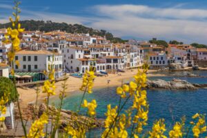 yellow and white houses near body of water during daytime