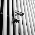 a security camera mounted to the side of a building