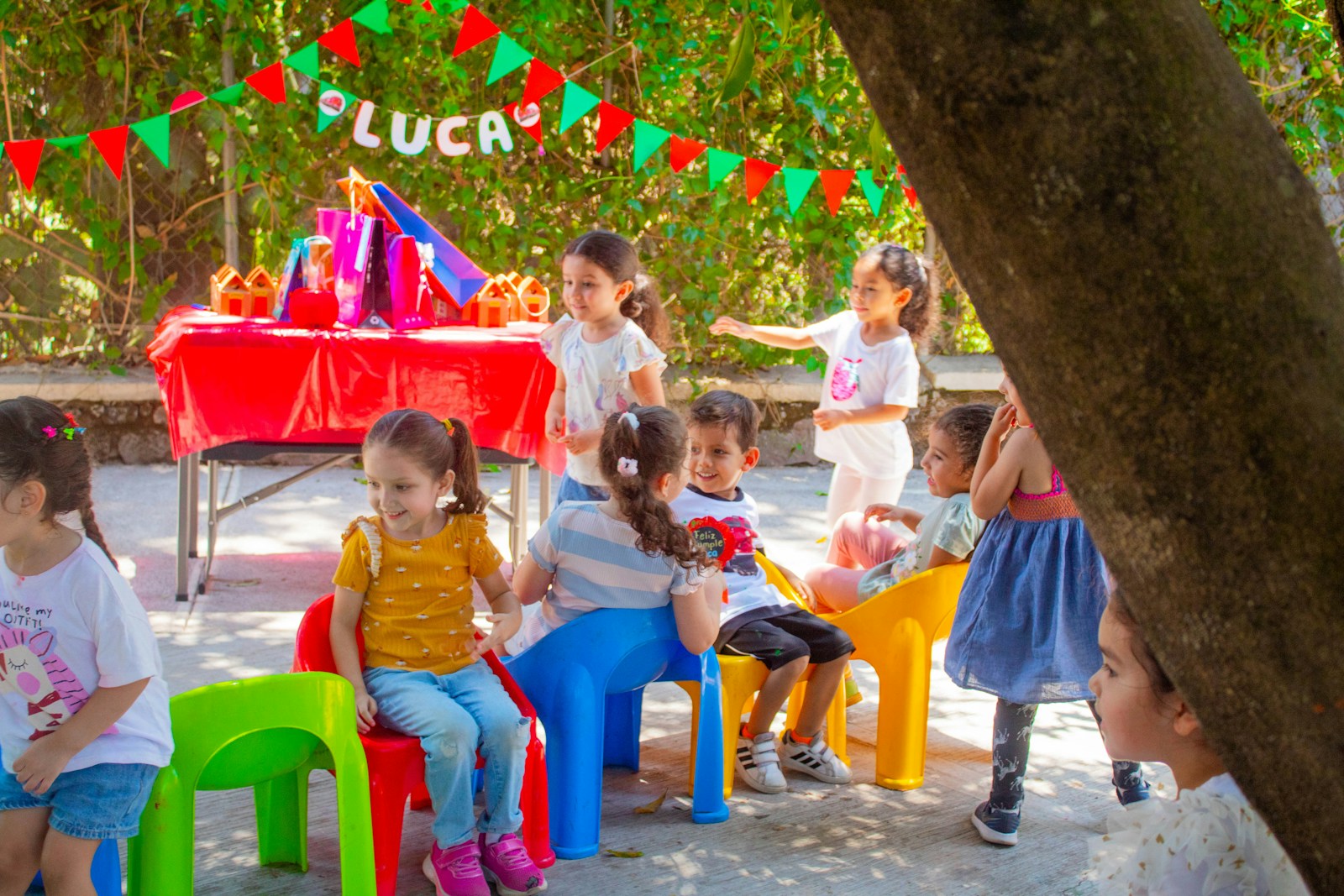 a group of children sitting around each other